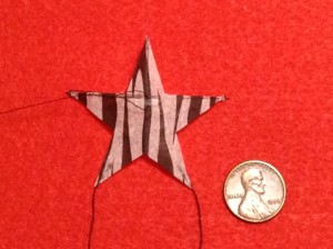 2 inch Sotich Star kite, striped cocktail napkin.