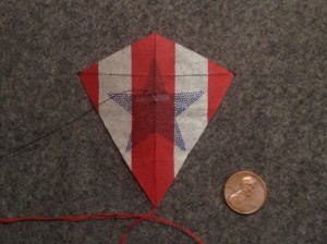 3 inch Sotich Eddy kite, cocktail napkin.