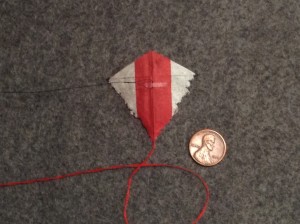 2 inch Sotich Eddy kite, cocktail napkin.